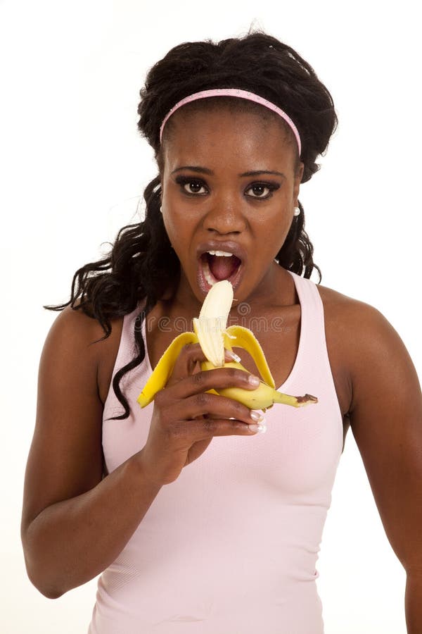 Woman pink top bite banana