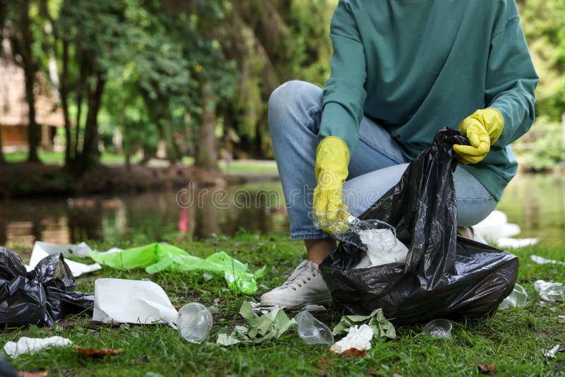 Woman with Plastic Bag Collecting Garbage in Park, Closeup Stock Image