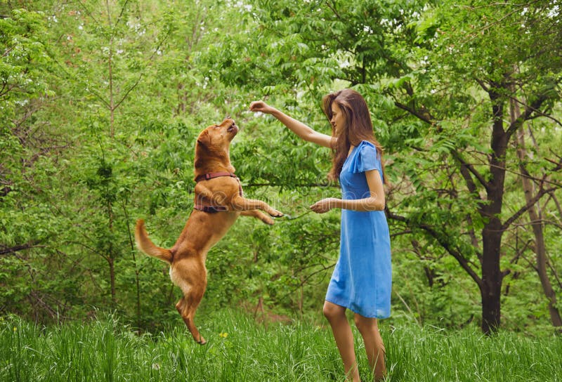 Woman is playing with dog