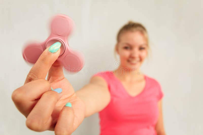 Woman playing fidget spinner royalty free stock photo Woman playing fidget spinner royalty free stock photo