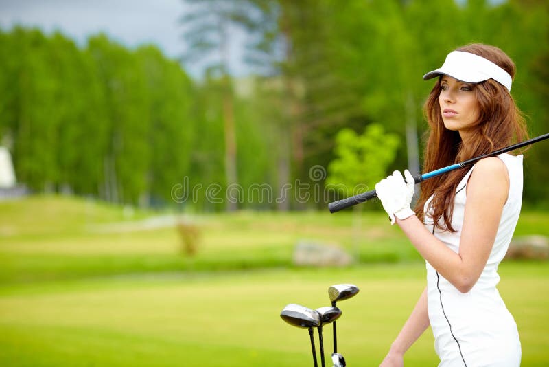 Woman playing golf on a green woman