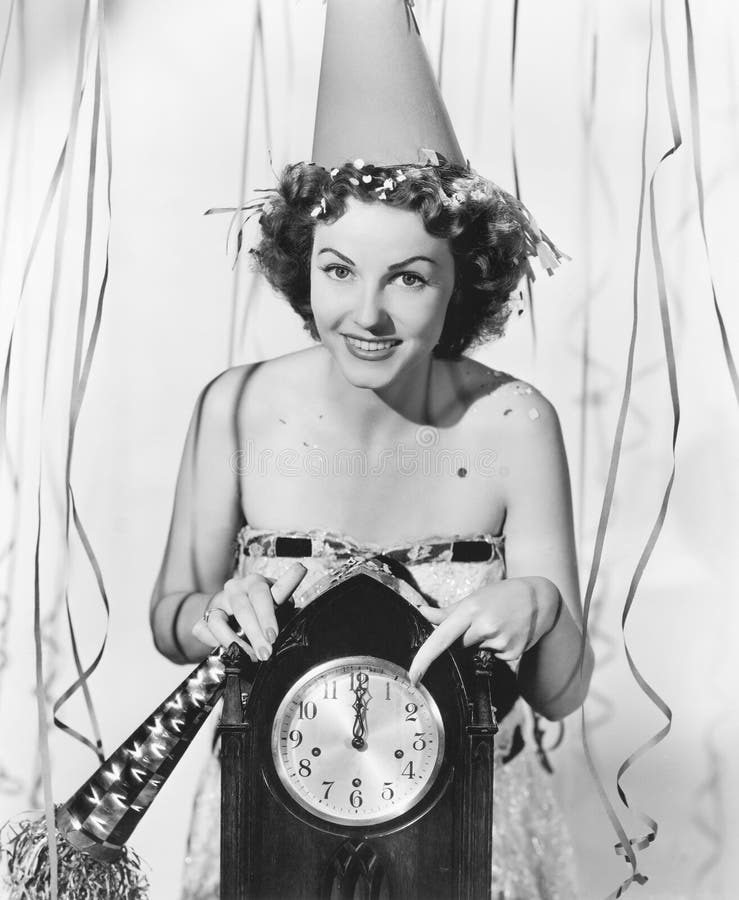 Woman pointing at the clock at midnight