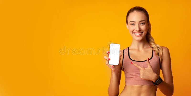 Woman Pointing Finger At Smartphone Blank Screen, Yellow Background, Mockup