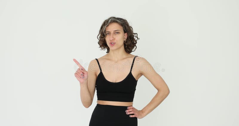 Woman pointing and refusing to point and shaking her head on white background stock footage