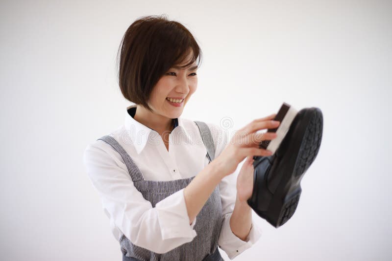 Woman Polishing Leather Shoes Stock Image - Image of family, indoor ...