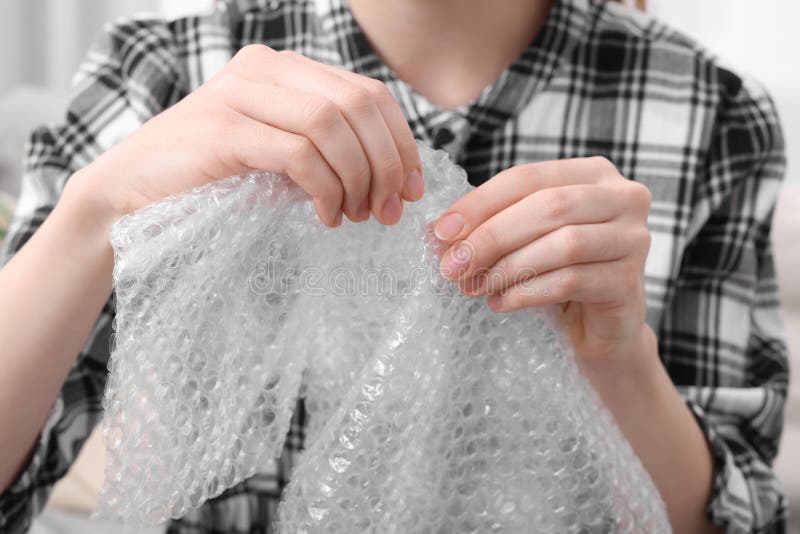 Woman Popping Bubble Wrap, Closeup. Stress Relief Stock Image - Image