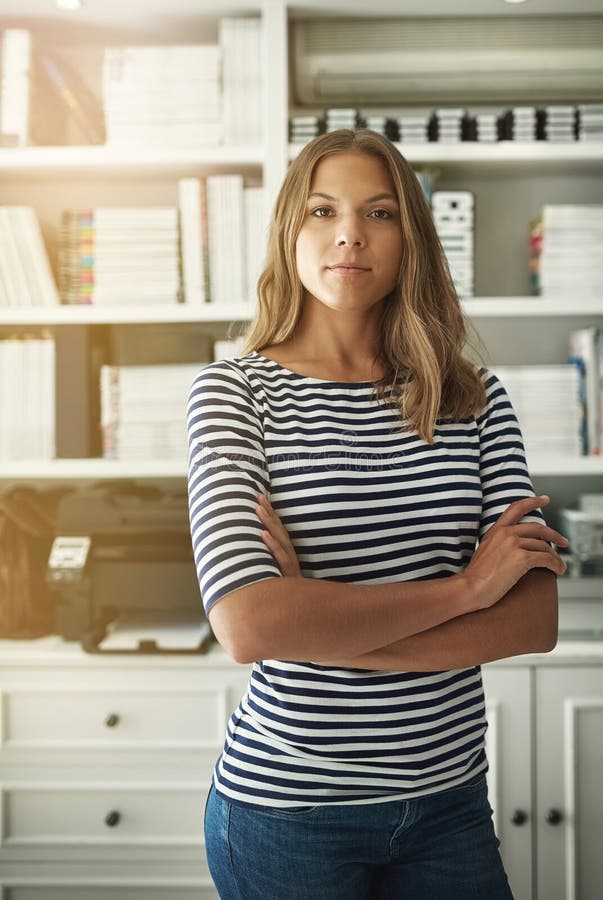 Woman, portrait and publisher in home office, arms crossed and bookshelf for editing fiction. Female person, story writer and proud of novel collection, confident and independent startup company. Editing project stock images, royalty-free photos and pictures