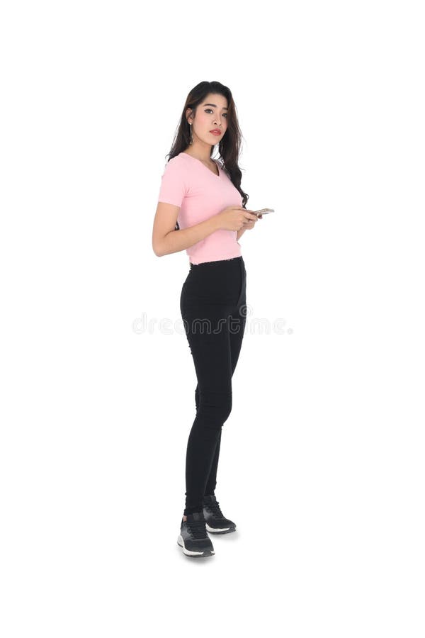 Full length colour studio portrait female wearing pink shirt and black  leggings on grey neutral background, hand placed on head Stock Photo - Alamy