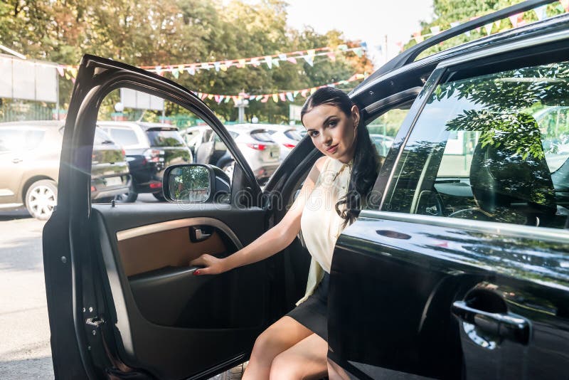 Woman Posing in Car with Open Door Stock Image - Image of looking ...