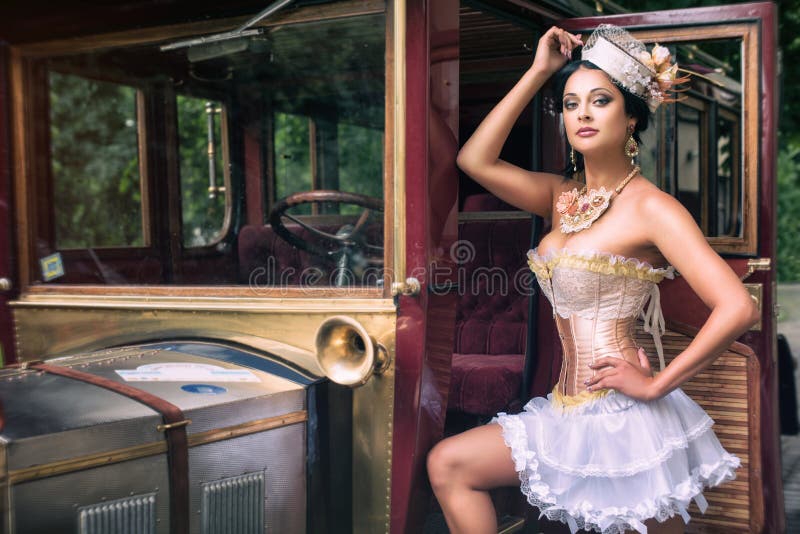 Woman posing over retro car