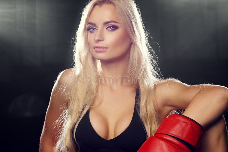 Woman posing in red boxing gloves