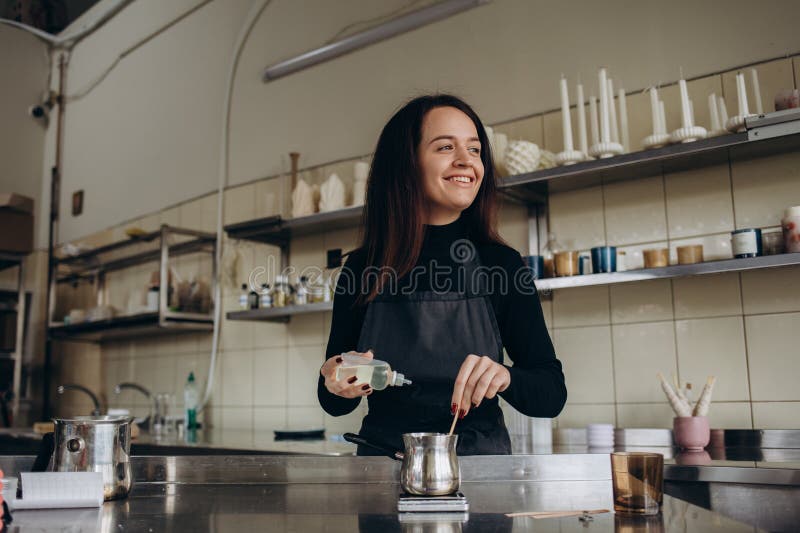 Woman Pouring Melted Wax into Amber Candles Container. Ecological and ...