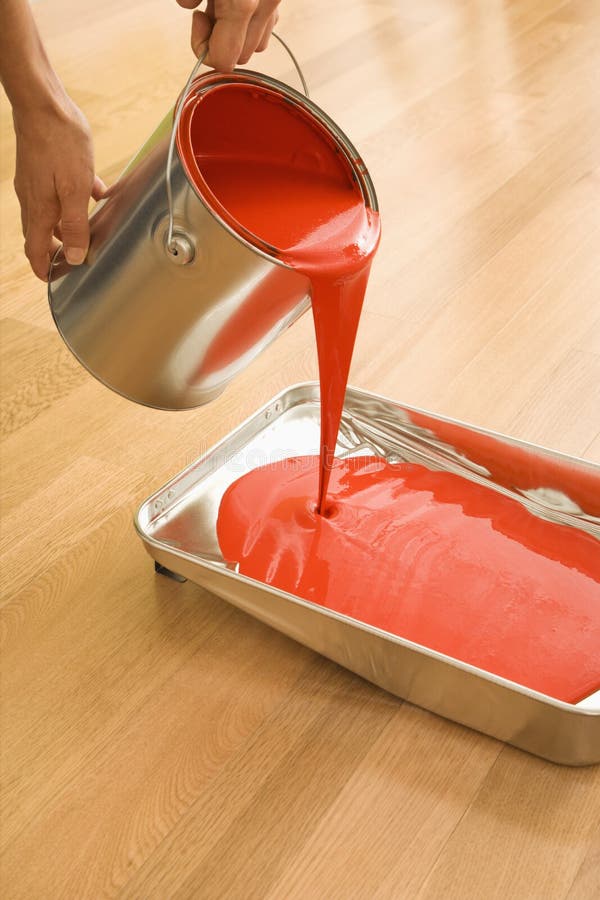 Hand pouring paint from tin can Stock Photo by ©anterovium 112589734