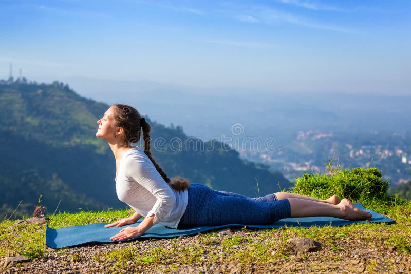 Woman practices yoga asana bhujangasana cobra pose stock photography Woman practices yoga asana bhujangasana cobra pose stock photography