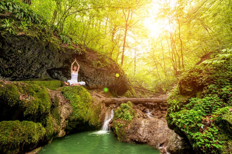 Woman Practices Yoga at the Waterfall. Sukhasana Pose Stock Image ...