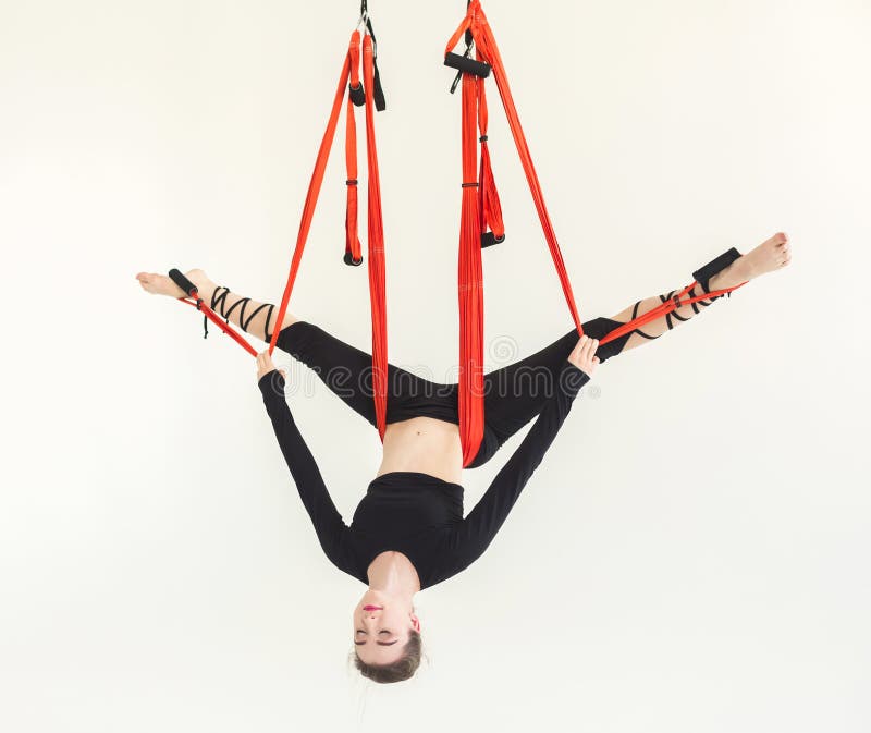 Woman practicing fly yoga over white background stock photo Woman practicing fly yoga over white background stock photo