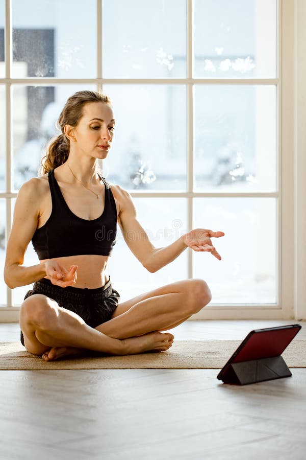 Premium Photo  Fit woman practicing chaturanga pose using online yoga  training program in the tablet at home