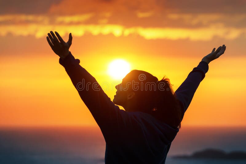 Woman praising and enjoying golden sunset stock photo Woman praising and enjoying golden sunset stock photo