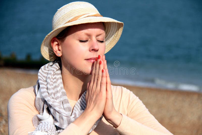 Woman praying to God stock photo