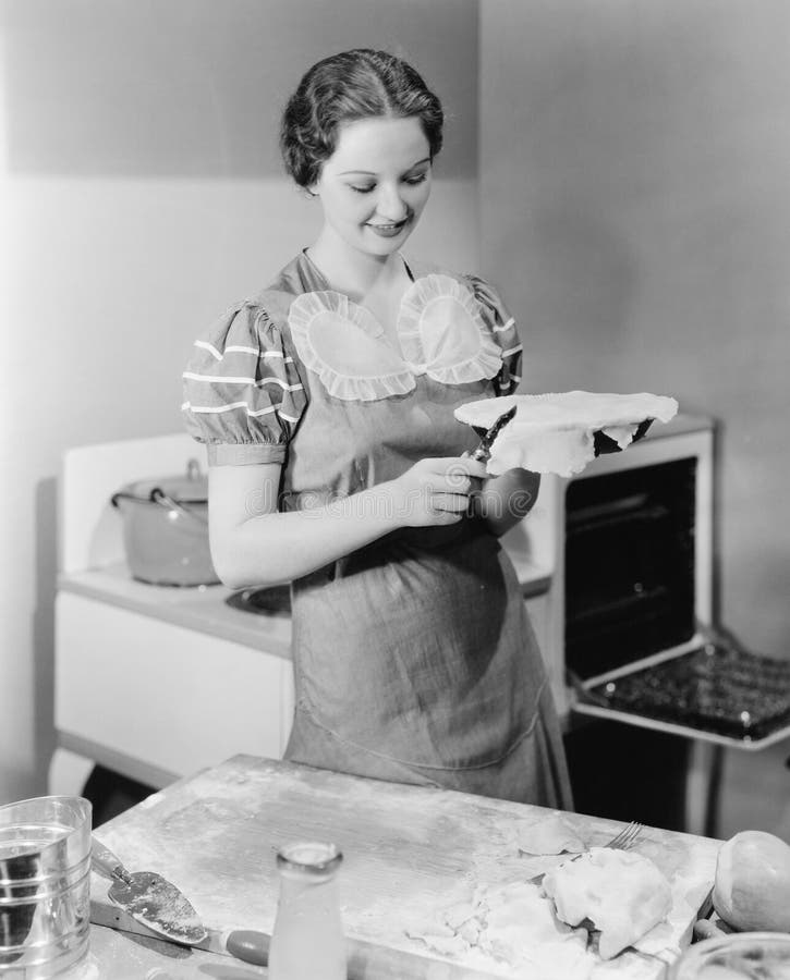 Woman preparing a pie in the kitchen stock image Woman preparing a pie in the kitchen stock image