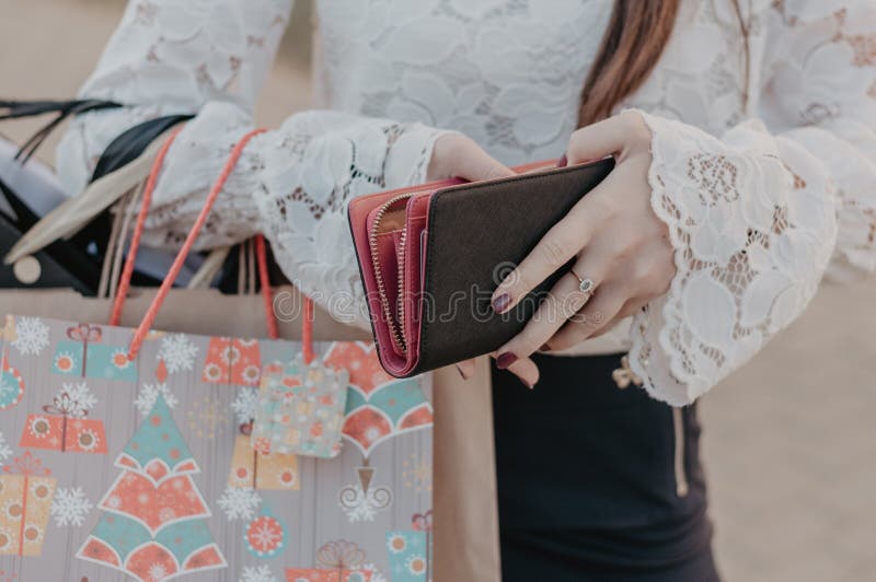 Woman with purchases holding a leather purse