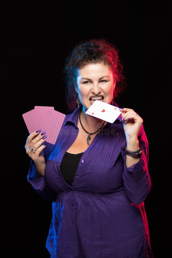 A Woman in Purple Clothes Holds a Deck of Cards and Shows Tricks Stock ...