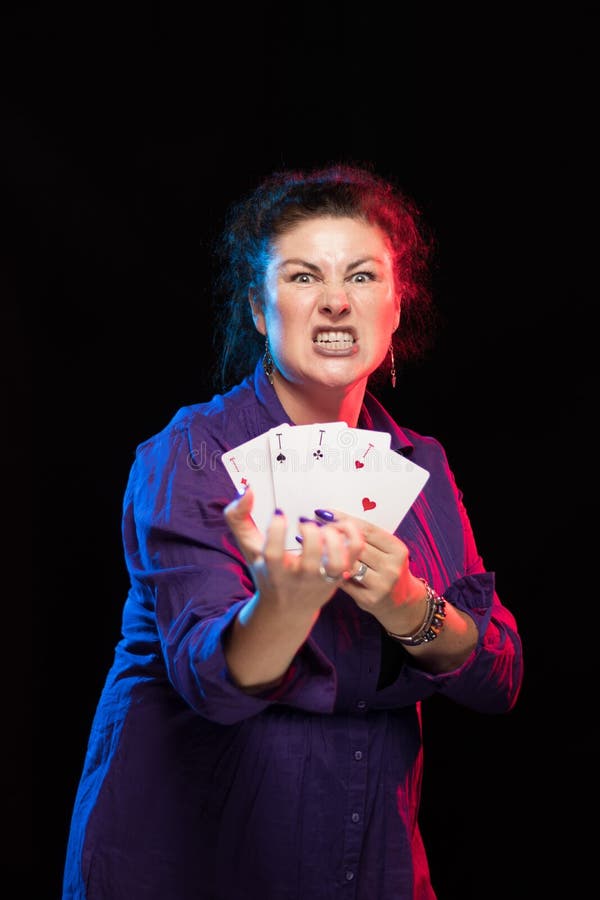 A Woman in Purple Clothes Holds a Deck of Cards and Shows Tricks Stock ...