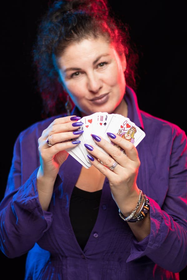 A Woman in Purple Clothes Holds a Deck of Cards Stock Photo - Image of ...
