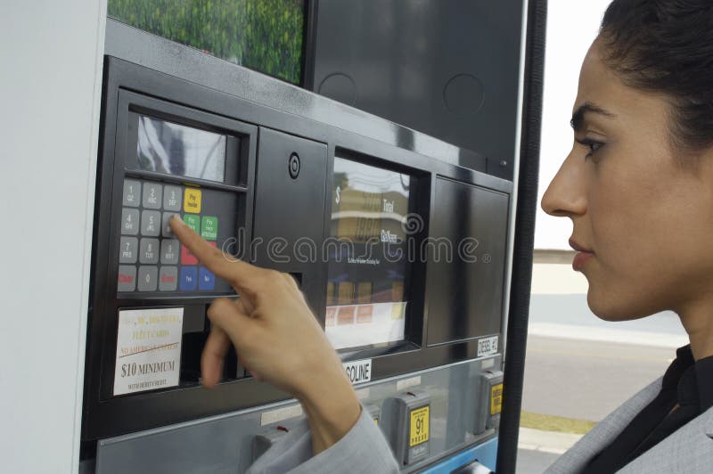 Woman Pushing Buttons On Fuel Pump