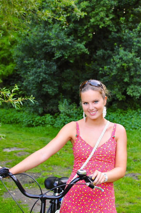 Woman pushing her bike in the woods royalty free stock images Woman pushing her bike in the woods royalty free stock images