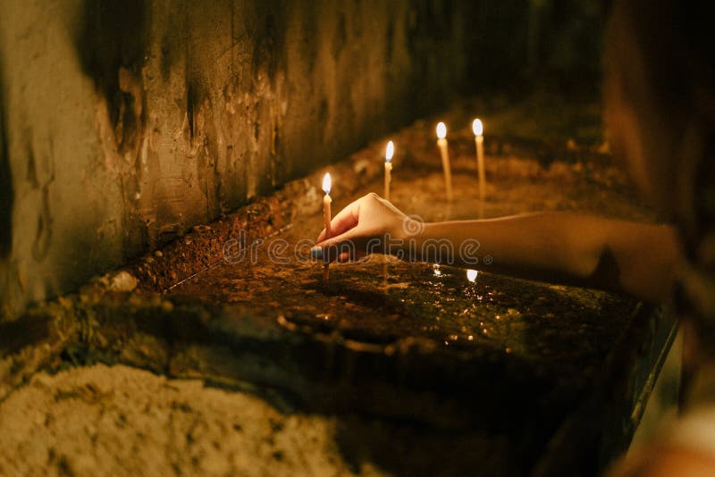 Woman Puts A Lighted Candle On A Candlestick Stock Photo Image Of