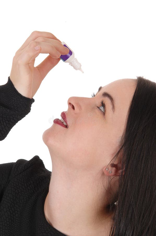 Woman putting eye drops in her dry eyes