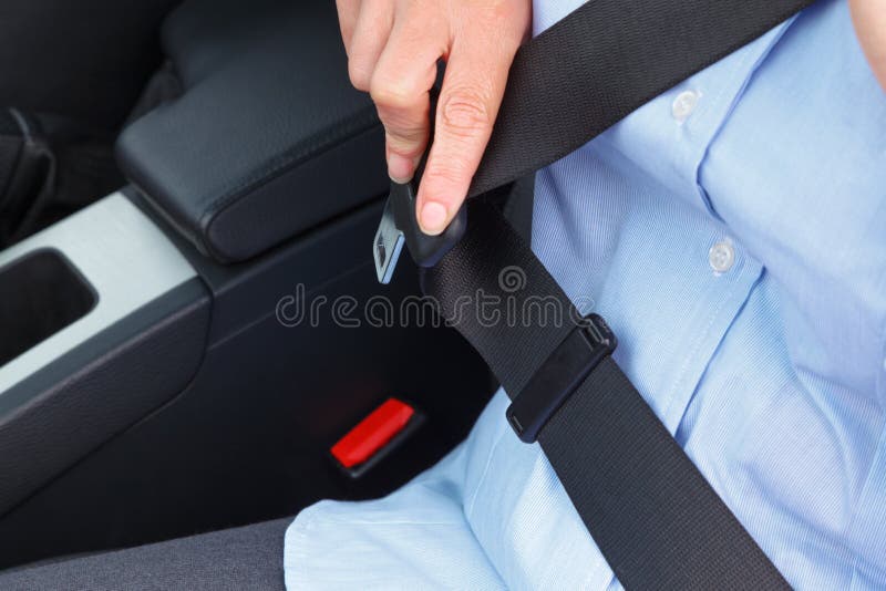 Guy Putting On Seat Belt Sitting In Car In Dealership Stock Image