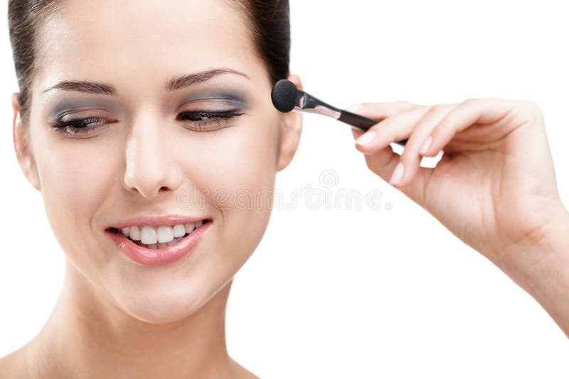 Woman putting on makeup with brush