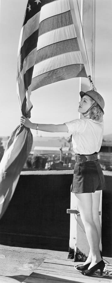 Woman raising American flag (All persons depicted are no longer living and no estate exists. Supplier grants that there will be no model release issues.)