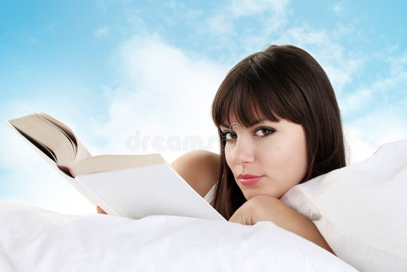 Woman reading in bed royalty free stock images Woman reading in bed royalty free stock images
