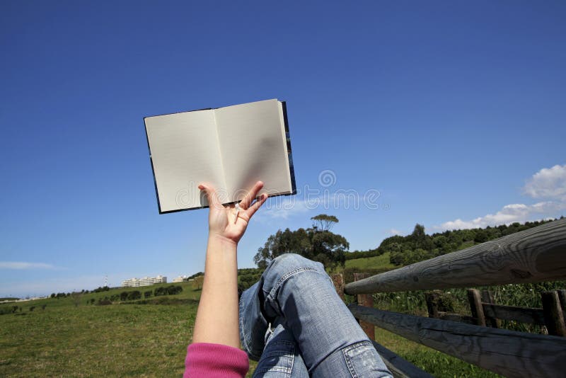 Woman reading book outdoors