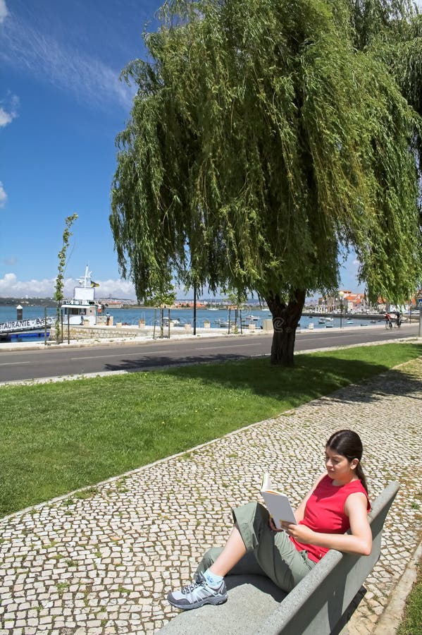 Woman reading book in park