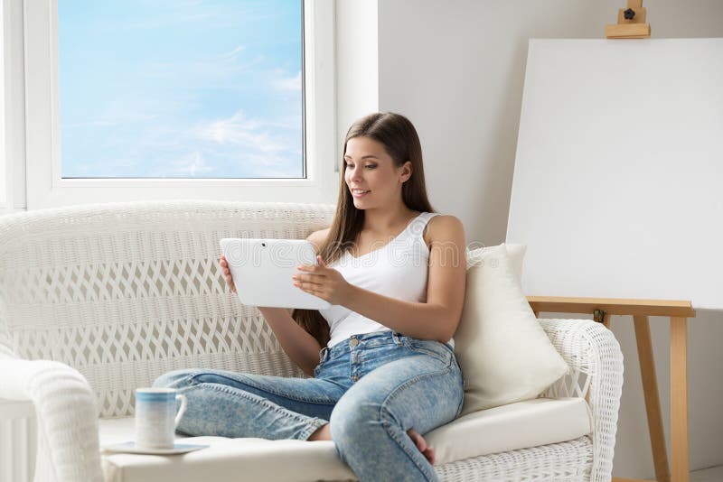 https://thumbs.dreamstime.com/b/woman-reading-tablet-pc-sitting-sofa-front-empty-easel-canvas-young-girl-using-touch-pad-screen-resting-next-to-window-216769592.jpg