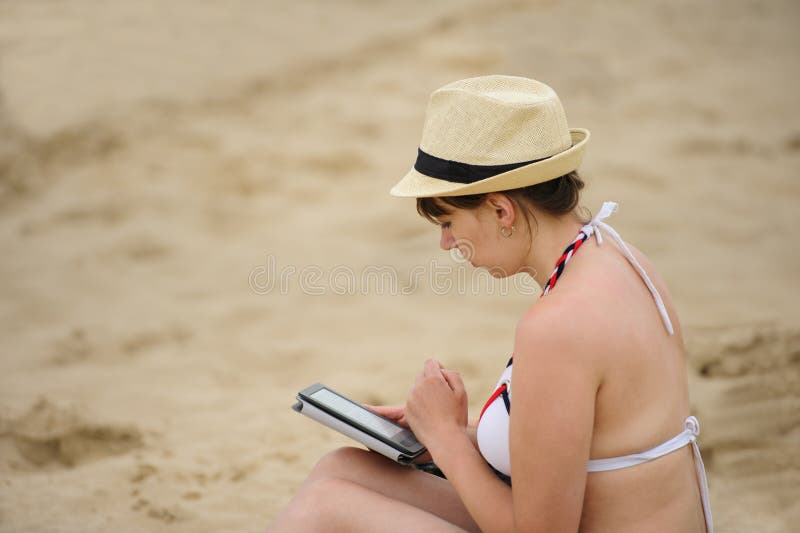 woman reading tablet reader on the beach royalty free stock image woman reading tablet reader on the beach royalty free stock image