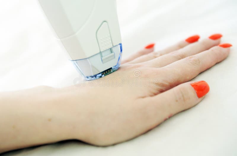 Woman receives laser and ultrasound treatment of face and body and hands in a medical sanatorium, skin rejuvenation concept