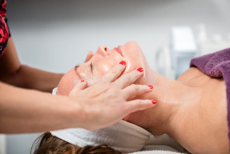 Woman Receiving Face Massage In Beauty Parlor