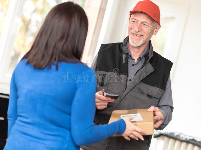 Woman receiving package from delivery man royalty free stock images Woman receiving package from delivery man royalty free stock images