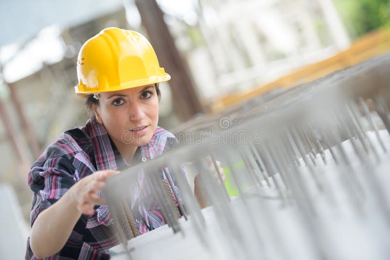 Woman recording and accounting metal profiles in stock