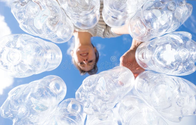 Woman recycling plastic water bottles high key