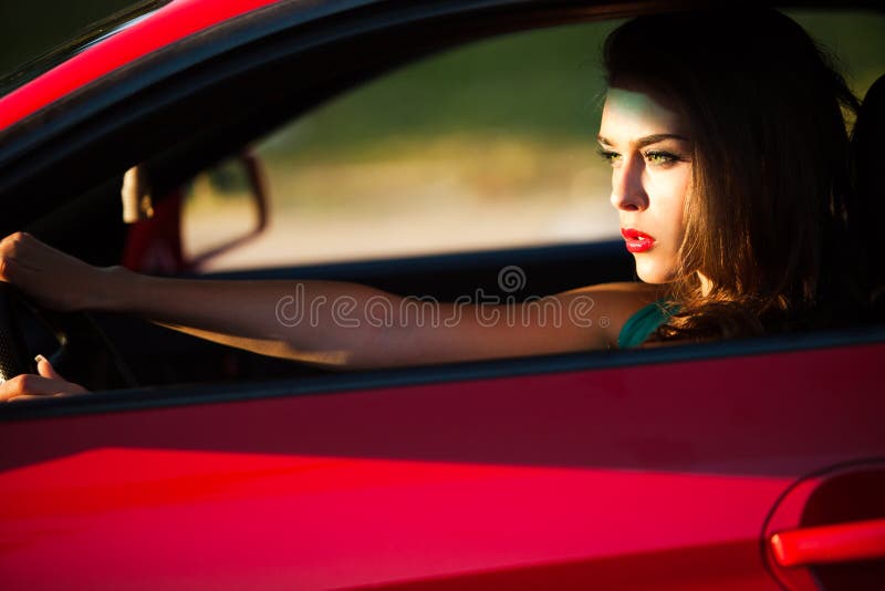 Woman in red car