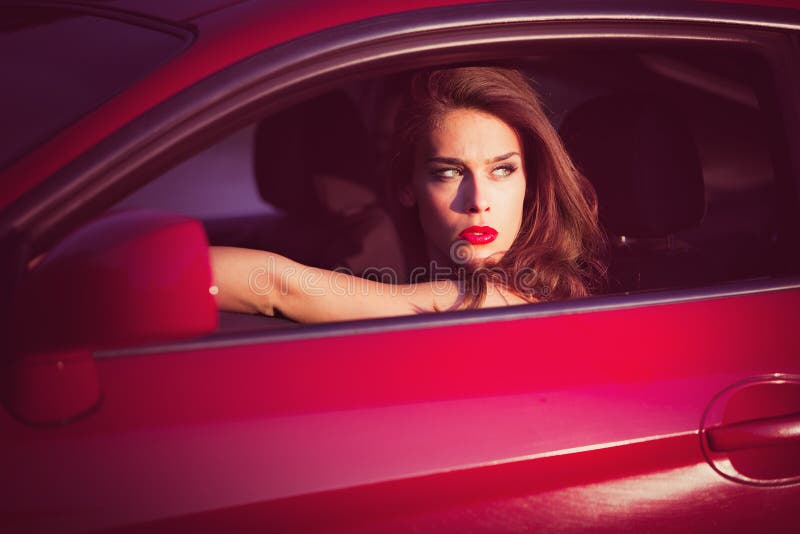 Woman in red car