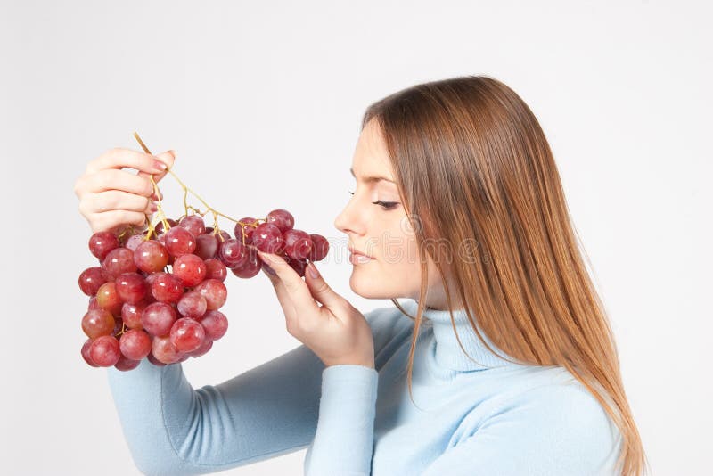 Woman with red grapes