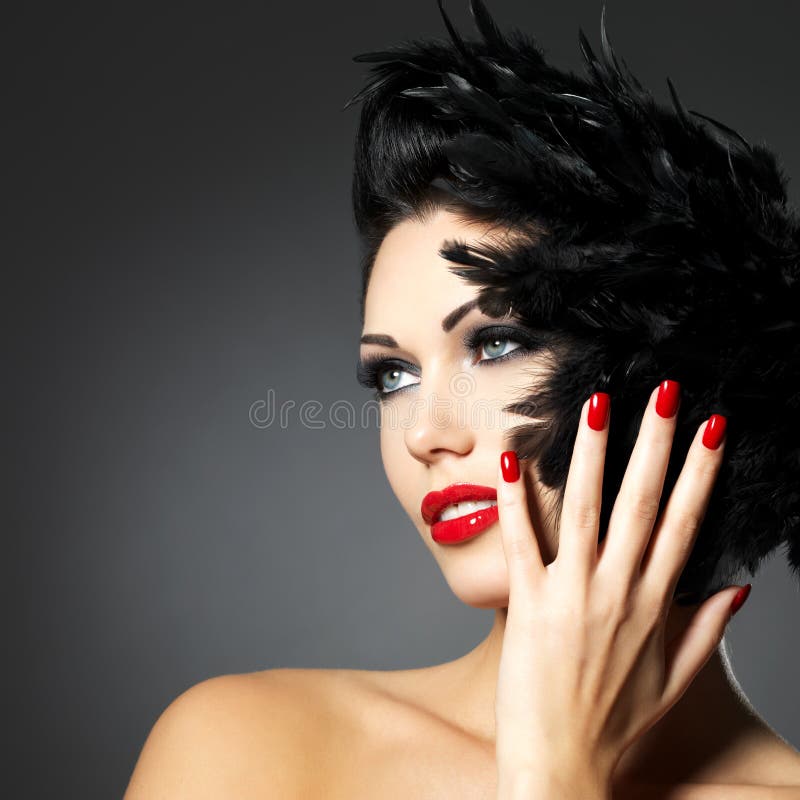 Beautiful fashion woman with red nails, creative hairstyle and makeup - Model posing in studio. Beautiful fashion woman with red nails, creative hairstyle and makeup - Model posing in studio