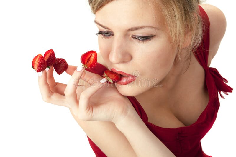 Woman with red strawberries picked on fingertips